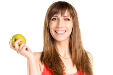 Young smiling girl holding green apple in hand. Fitness woman