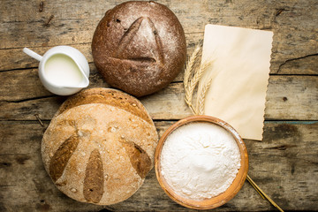 Different loafs of bread with bakery ingredients