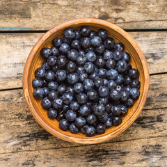 Top view of fresh wild berries on wood background