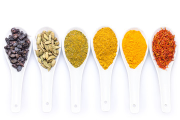 Diverse of spices in ceramic spoon isolated on white background