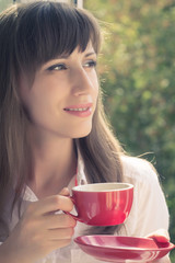 Beautiful smiling young hipster women drinking tea