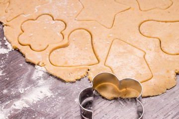 Cutting Christmas gingerbread cookies from rolled out dough