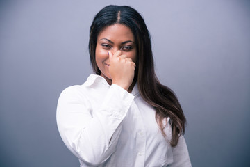 African businesswoman covering her nose