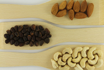 Abstract view of wooden shovels with mixed nuts