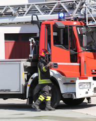 fireman and a firetruck in the barracks of the fire brigade