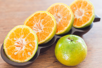 Slice of fresh orange in wooden tray