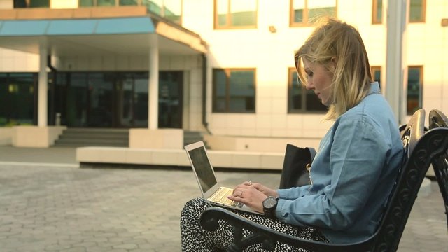 Female journalist hands typing on notebook
