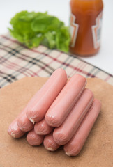 hot dog sausages on wood pad