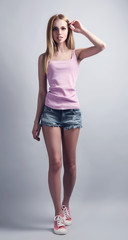Fototapeta premium Expressive young model in casual style on gray background