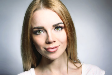 Fototapeta premium Portrait of beautiful young woman on gray background