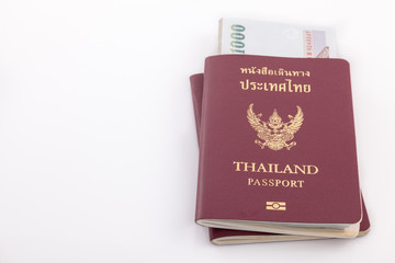 Thailand passport and Thai money for travel isolated on white ba