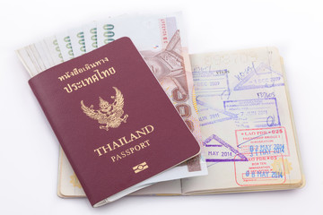 Thailand passport and Thai money for travel isolated on white ba