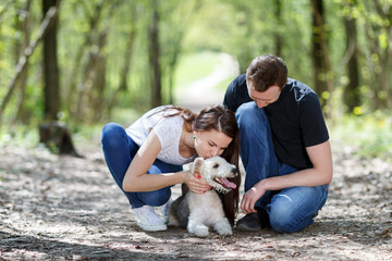 Fototapeta premium Happy young couple and dog