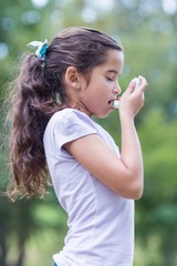 Little boy using his inhaler