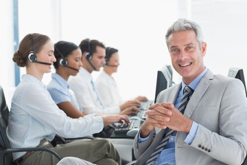 Businessman with executives using computers