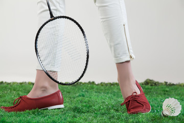 Woman's Legs And Badminton Racket