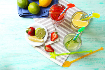 Cocktails with fresh strawberries and lemon lime on wooden background