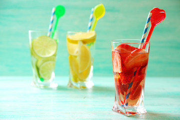 Cocktails with fresh strawberries and lemon lime on wooden background