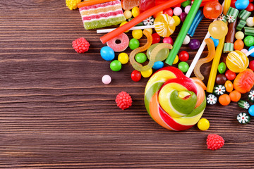 Colorful candies on wooden background