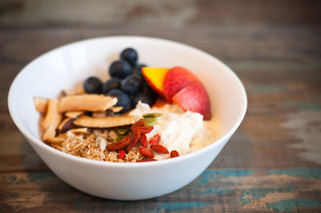 Breakfast muesli made with Greek yogurt and topped with fresh nectarines, blueberries, coconut and goji berries. Packed with vitamins this homemade muesli a healthy and nutritious start to the day.