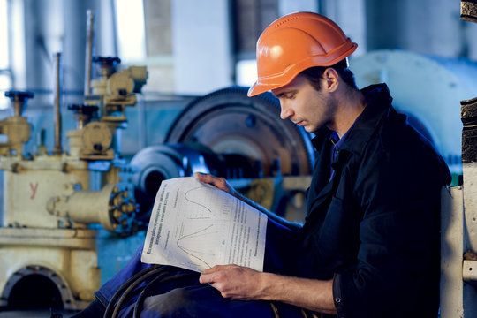 Worker On Industry Studying Manual Instructions Repair Turbine.