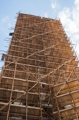 Wooden scaffolding around old building