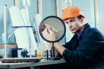 Laboratory worker in helmet research oil biofuels.