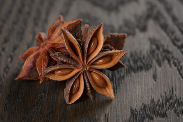 anise stars on old oak table close up photo