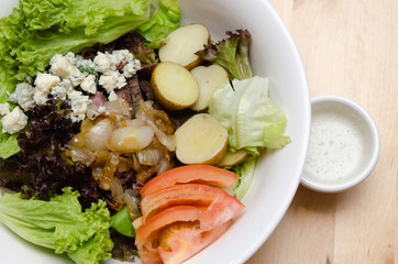 Grilled beef salad with tomato, potato, onion