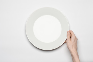 the human hand show gesture on an empty white plate in studio