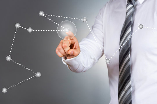 Modern businessman pointing at business graph.