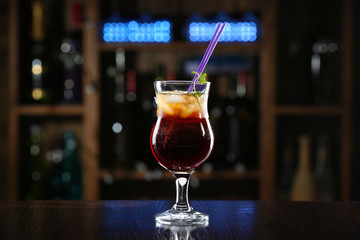 Glass of cocktails on bar background