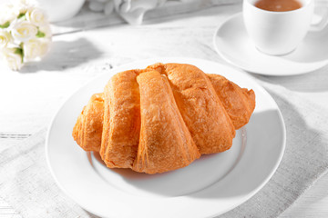 Delicious croissants on plate on table close-up