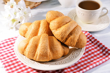 Delicious croissants on plate on table close-up