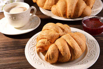 Delicious croissants on plate on table close-up