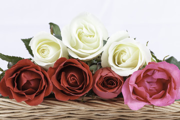 beautiful bouquet roses  in basket on white background