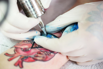 Tattoo artist at work, close-up