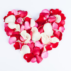 Heart made out of rose petals on white