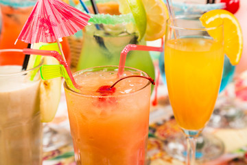 different fresh cocktails with ice in glasses with drinking stra