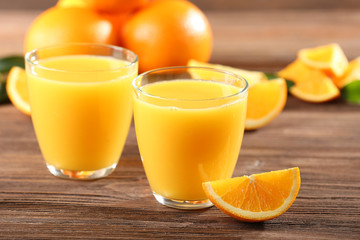 Orange juice on table on wooden background
