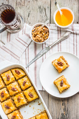 pieces of baklava with honey and nuts, top view, rustic