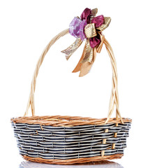 Fototapeta na wymiar Empty wicker basket with ribbon isolated on white background