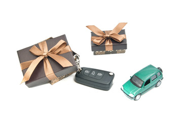 two brown gift boxes, green car and keys