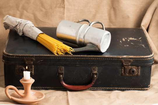 an old cardboard suitcase with vintage items