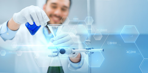 close up of scientist with test tubes and funnel