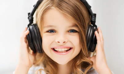 Fototapeta premium little girl with headphones at home