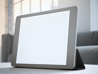 Tablet with blank screen on table