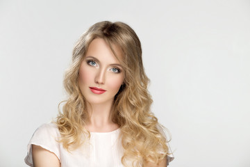Portrait of young blond girl with makeup and retouch