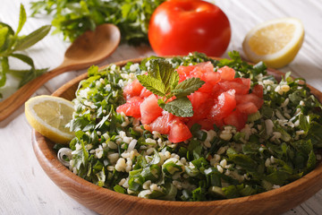 Vegetarian salad Tabbouleh closeup and ingredients. Horizontal
