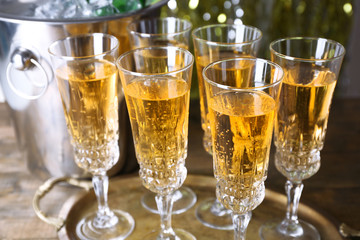 Glasses of champagne on bright background
